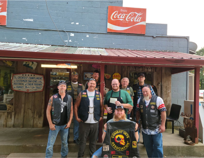 the combat vet biker club giving a donation to Micah in from of Southern Reds restaurant